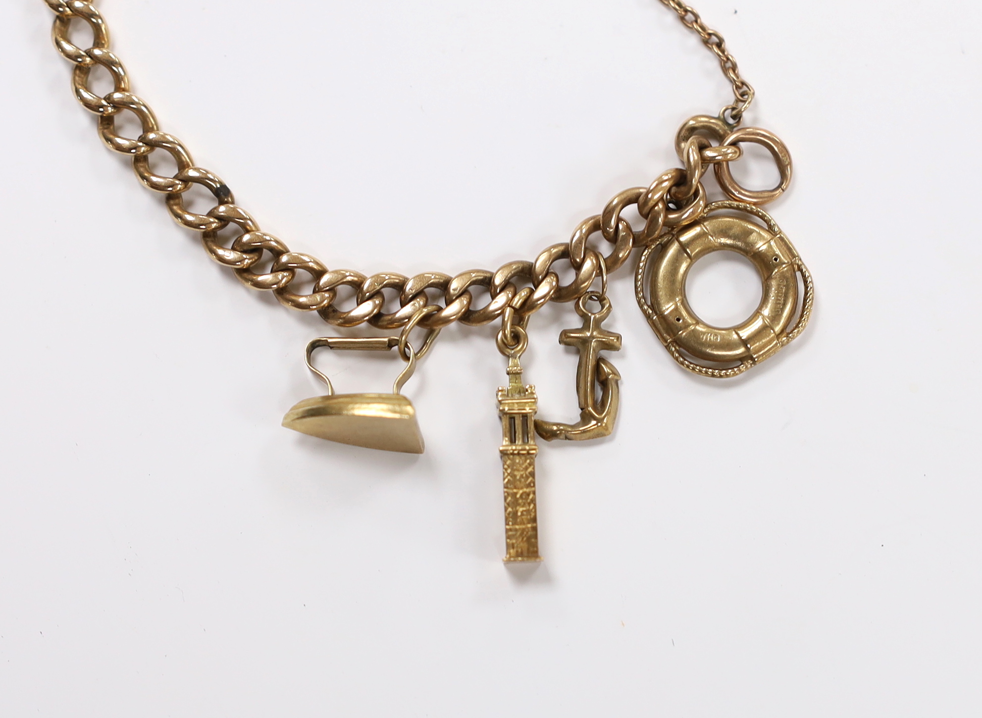 A 9ct curb link charm bracelet, hung with six assorted charms, including five 9ct gold, gross weight 19 grams.
